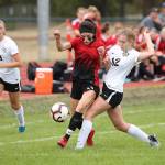 Mallory Kortuem, left, mixes it up with a Meridian player.(Photo by John Fisken)
