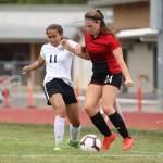 Eryn Wood, right, fights off a Meridian defender.(Photo by John Fisken)