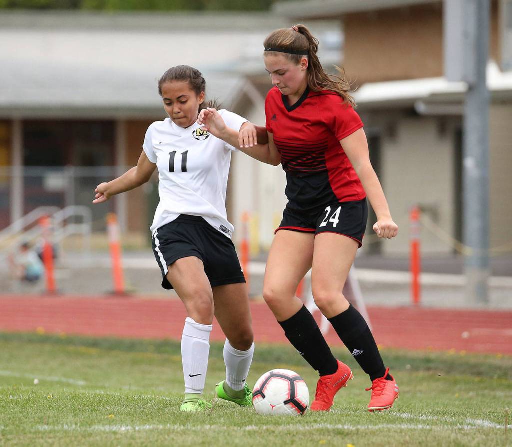 Eryn Wood, right, fights off a Meridian defender.(Photo by John Fisken)