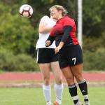 Genna Wright, right, heads the ball for the Wolves.(Photo by John Fisken)
