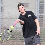 Mason Grove swats a forehand in first doubles.(Photo by John Fisken)