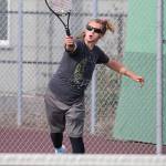 Thane Peterson unleashes a serve in third doubles.(Photo by John Fisken)