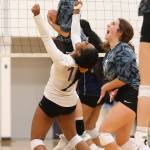Oak Harbors Jaslin Webster (white jersey), Leielle Salinger (back) and Annie Salinger celebrate Thursdays win. (Photo by John Fisken)