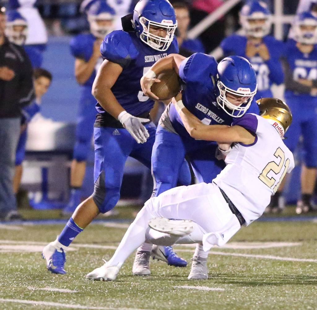 Calvin Whelpley makes a tackle for Oak Harbor.(Photo by John Fisken)
