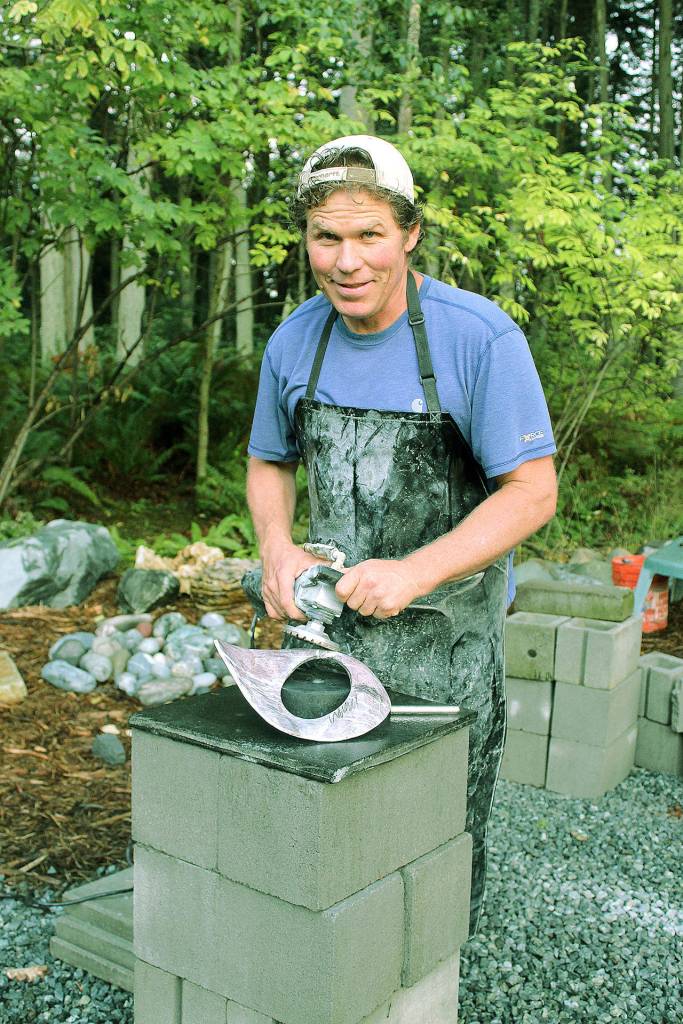 Artisan Rick Hahn creates a natural stone sculpture at the Earth2Art Studio shared with his wife, wood sculpture artist Rayna Hahn. The couple is hosting an open-studio afternoon for Whidbey Island Grown Week. Photo by Wendy Leigh/ Whidbey News Group
