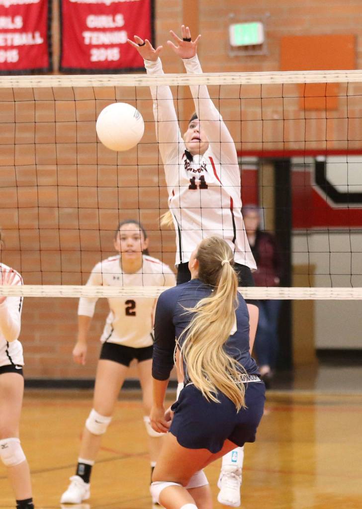 Hannah Davidson (11) records one of her five blocks in the CPC match. (Photo by John Fisken)