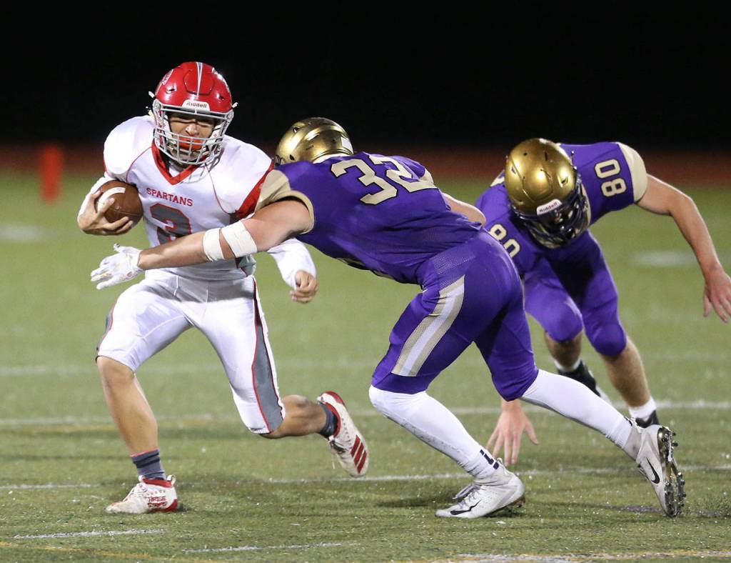 Jake Mitten (32) zeroes in on Stanwoods Wyatt Custer.(Photo by John Fisken)