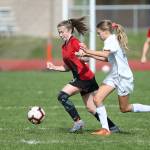 Sophia Martin, left, wins the race to the ball.(Photo by John Fisken)
