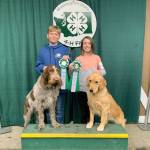 Theron Hull-Walton and Madison Thompson, members of K-9 Korps club, hold their award with their respective dogs Hank, left, and Stella. (Photo provided)