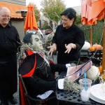 May I take your order? Nancy Hernandez asks Dracula, at Ciao Restaurant. He would like a Bloody Mary, she guessed, as the caped vampire took his time responding. She and Greg McCormick, left, of Ciao enjoyed some Halloween fun at the restaurants decorated outdoor seating area. Photos by Maria Matson/Whidbey News-Times