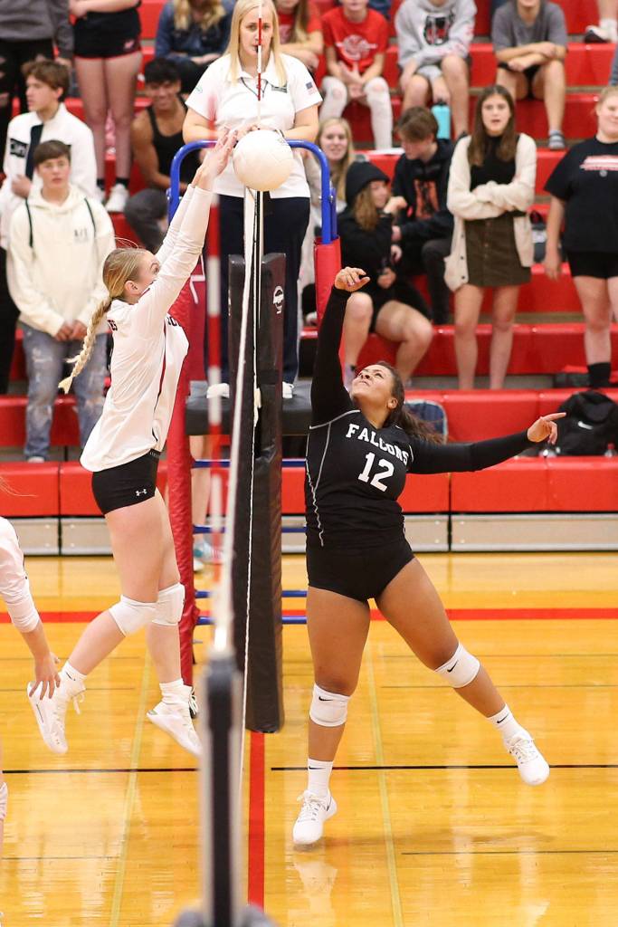 Chelsea Prescott, left, blocks a tip by South Whidbeys Maya Tschetter.(Photo by John Fisken)
