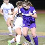Peyton Rhyne fights Shorewoods Jadyn Smith for possession.(Photo by John Fisken)