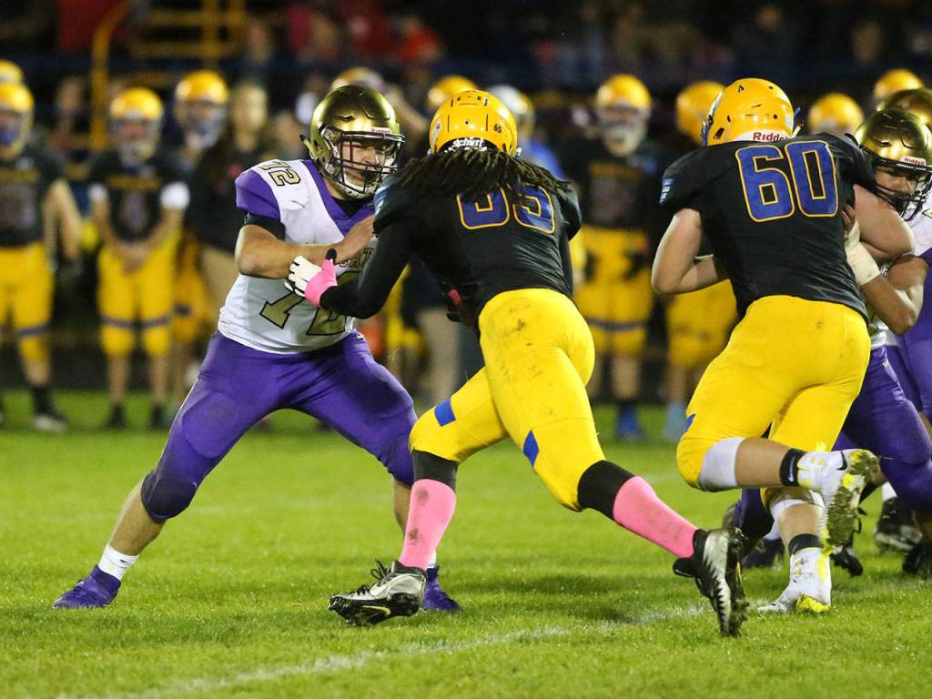 Jackson Higman, left, blocks Ferndales Malachi Ledbetter.(Photo by John Fisken)