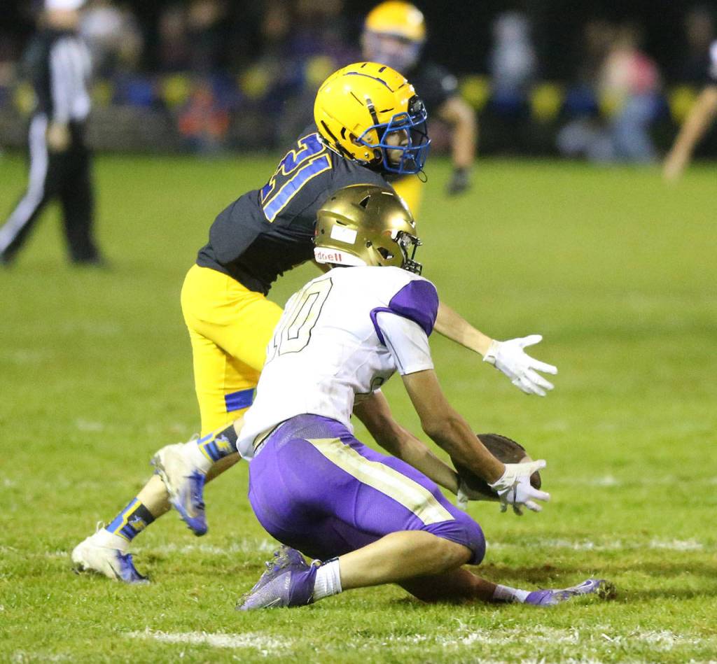 Matt Kelley scoops up a pass in front of Ferndales Jonathan Salazar.(Photo by John Fisken)