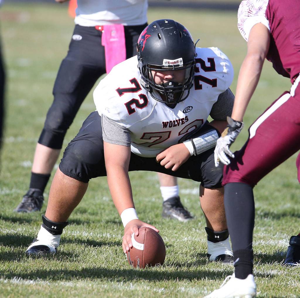 Coupeville center Isaiah Bittner prepares to snap the ball. (Photo by John Fisken)
