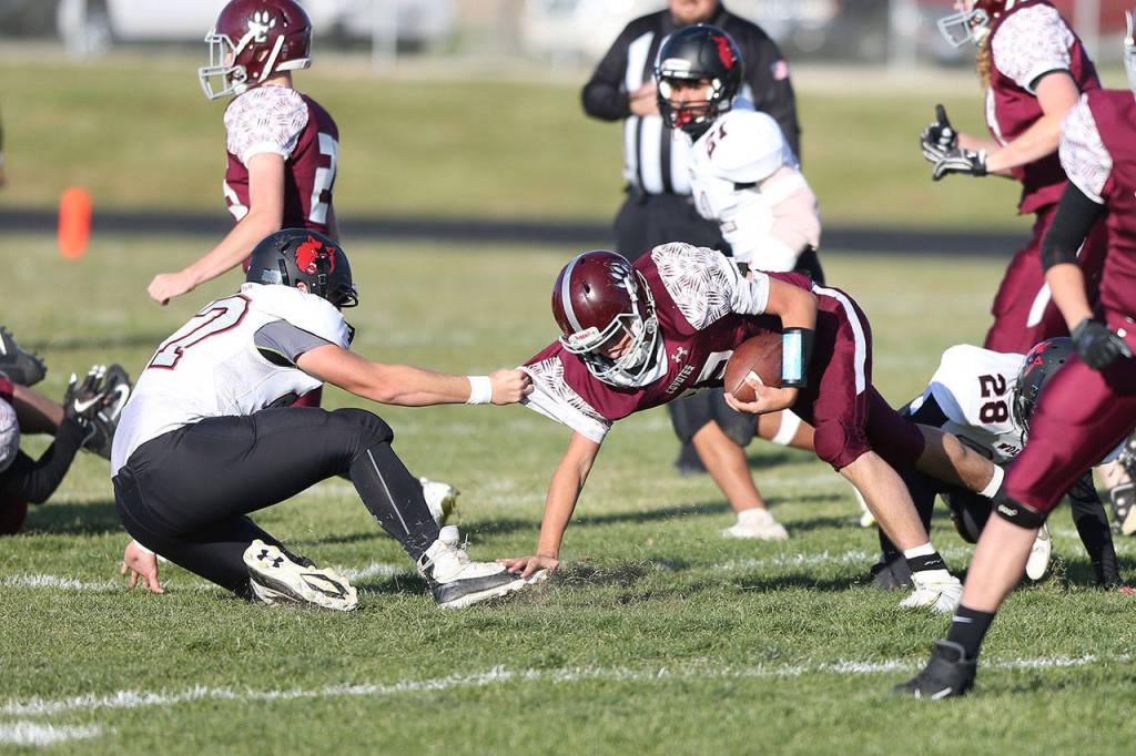 Gabe Shaw pulls down Kittitas quarterback Blake Catlin.(Photo by John Fisken)