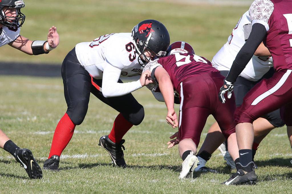 Kai Wong (63) sets a block for Coupeville.(Photo by John Fisken)