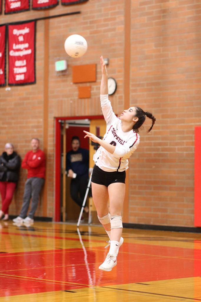 Raven Vick launches a serve for Coupeville.(Photo by John Fisken)