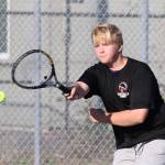 Miles Davidson fires a forehand in third doubles.(Photo by John Fisken)