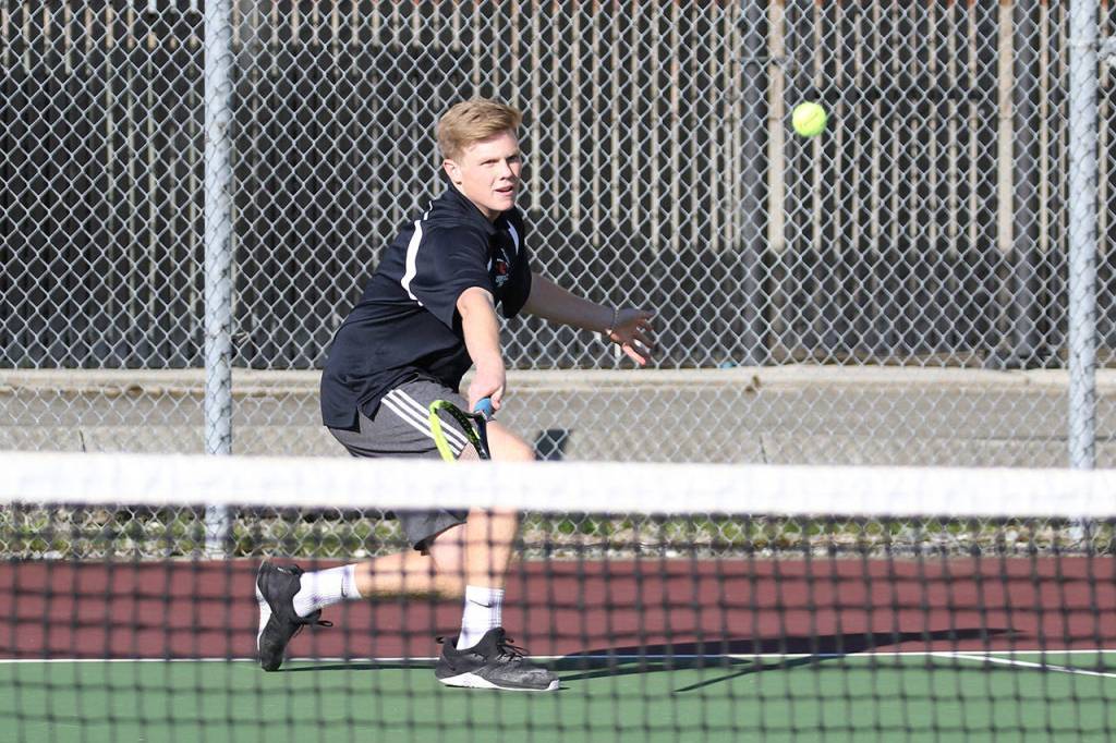 Mason Grove flips a backhand shot over the net.(Photo by John Fisken)