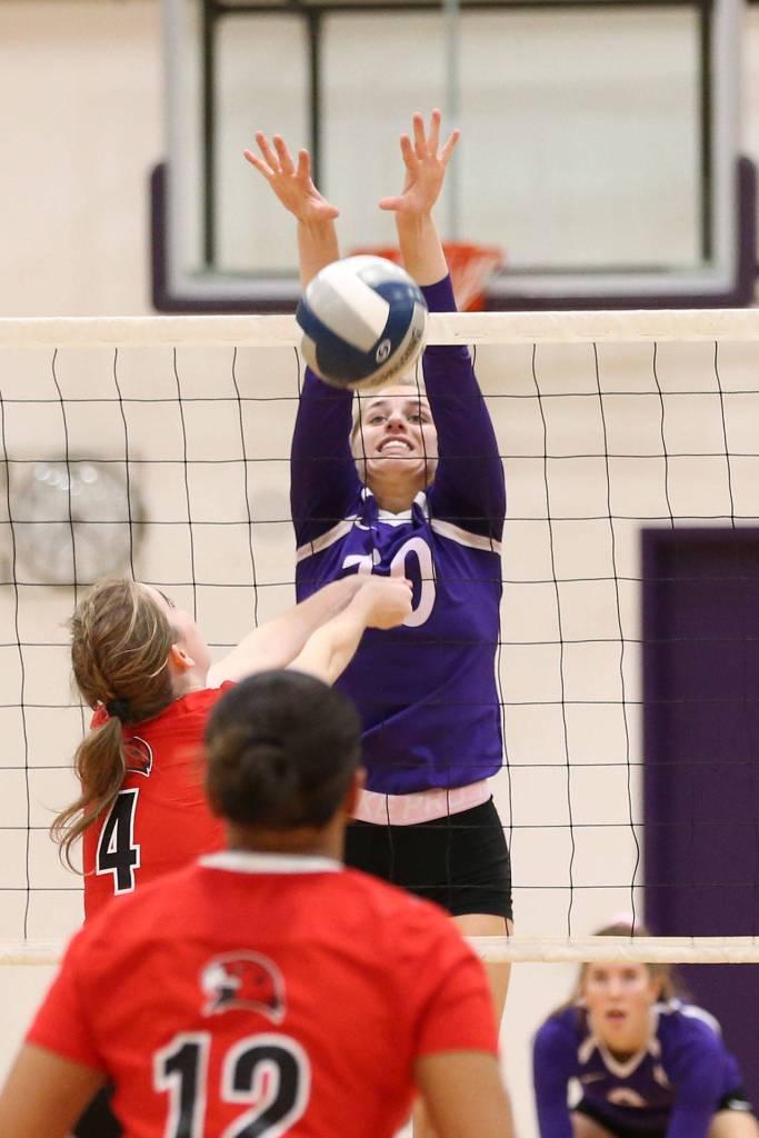 Morgan Pease rises to block for the Wildcats.(Photo by John Fisken)