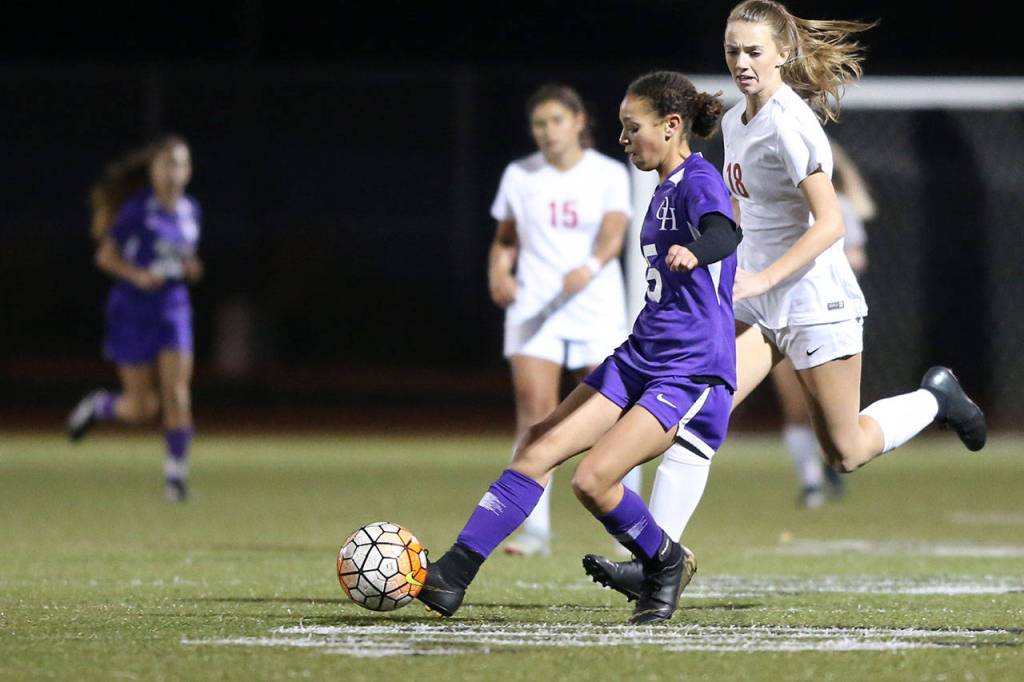Tessa Hughes takes possession for Oak Harbor.(Photo by John Fisken)