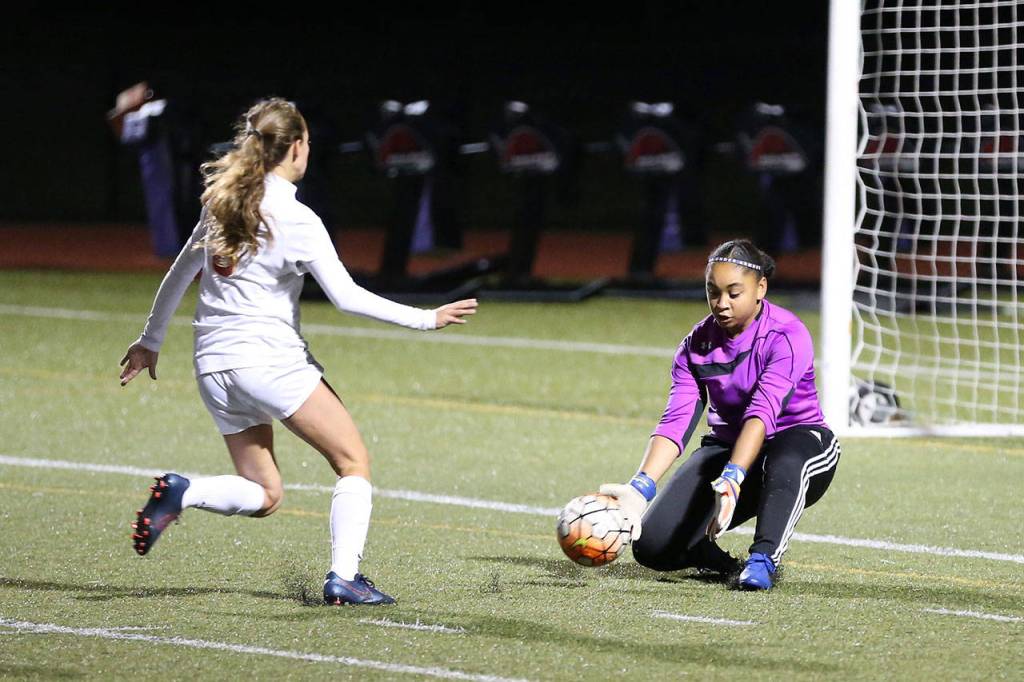 Oak Harbor goalkeeper Tiana Jackson scoops up a Stanwood shot. Jackson moved to the front in the second half and scored both Oak Harbor goals.(Photo by John Fisken)