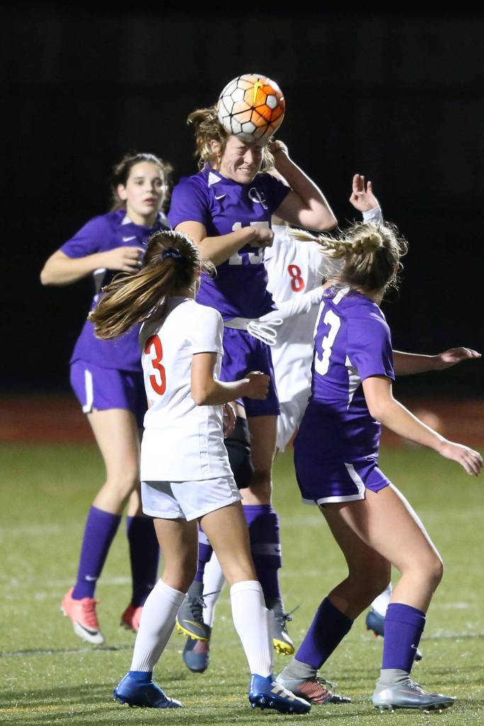 Chloe Wallace heads the ball in traffic for Oak Harbor.(Photo by John Fisken)