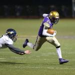 Brenden Andersen slips by an Arlington defender. (Photo by John Fisken)
