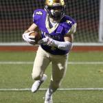 Landon Cantrell returns a kick for the Wildcats.(Photo by John Fisken)