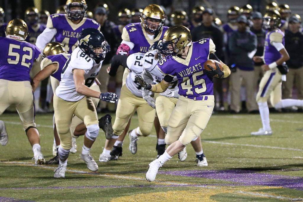 Caden Leckelt (45) tries to avoid Arlington defenders.(Photo by John Fisken)