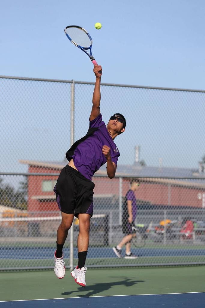 Jerome Dones serves against Mariner.(Photo by John Fisken)