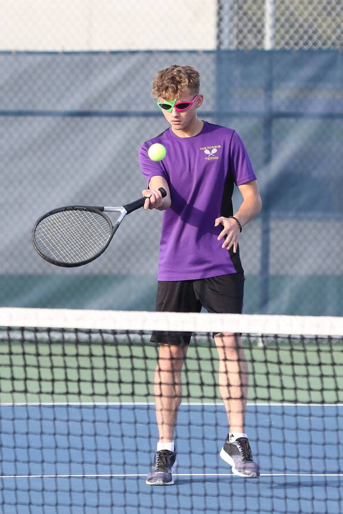 Ethan Snell flips it over the net during second doubles Monday.(Photo by John Fisken)