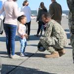Petty Officer 1st Class Jessie Ewing of VP-40 is greeted by his daughter Gala Ewing Thursday. He returned to Whidbey Island with the last active duty P-3C Orion.
