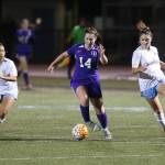 Oak Harbors Peyton Rhyne (14) splits Everett defenders Caroline Santra (2) and Sammy Strange (3). Rhyne tallied two goals for the Wildcats in the 3-0 win.(Photo by John Fisken)