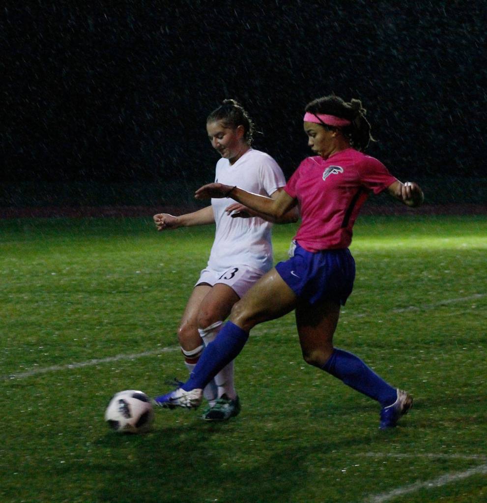 Coupevilles Tia Wurzrainer, left, tangles with South Whidbeys Simone White for possession.(Photo by Jim Waller/Whidbey News-Times)