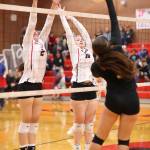 Scout Smith, left, and Hannah Davidson put up a block.(Photo by John Fisken)