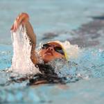 Frances Empinado helps Oak Harbor win the medley relay.(Photo by John Fisken)