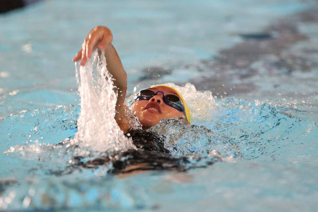 Frances Empinado helps Oak Harbor win the medley relay.(Photo by John Fisken)
