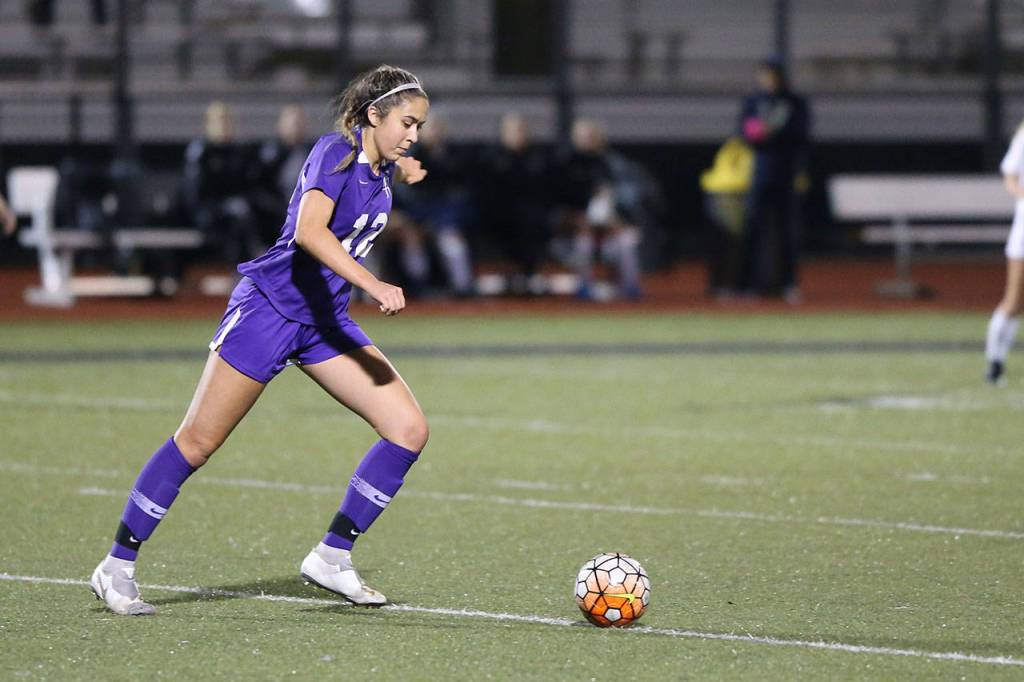 Oak Harbors Mikhaela Cortez, a four-year starter, puts the ball back into play.(Photo by John Fisken)