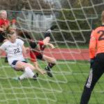 Mallory Kortuem, center, is upended by Sultans Kennedy Wolff. No penalty was called on the play.(Photo by Jim Waller/Whidbey News-Times)