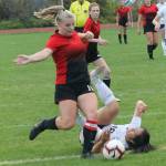 Avalon Renninger takes care of the ball and Sultans Heidi Milian.(Photo by Jim Waller/Whidbey News-Times)