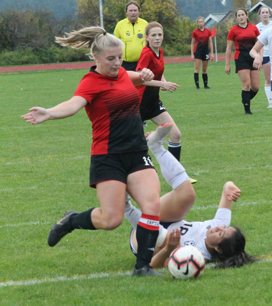 Avalon Renninger takes care of the ball and Sultans Heidi Milian.(Photo by Jim Waller/Whidbey News-Times)