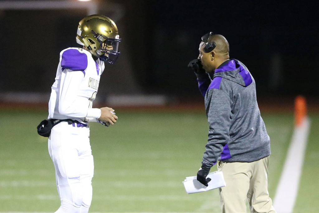 Oak Harbor quarterback Cameron Asinsin, left, and coach Marcus Hughes. (Photo by John Fisken)