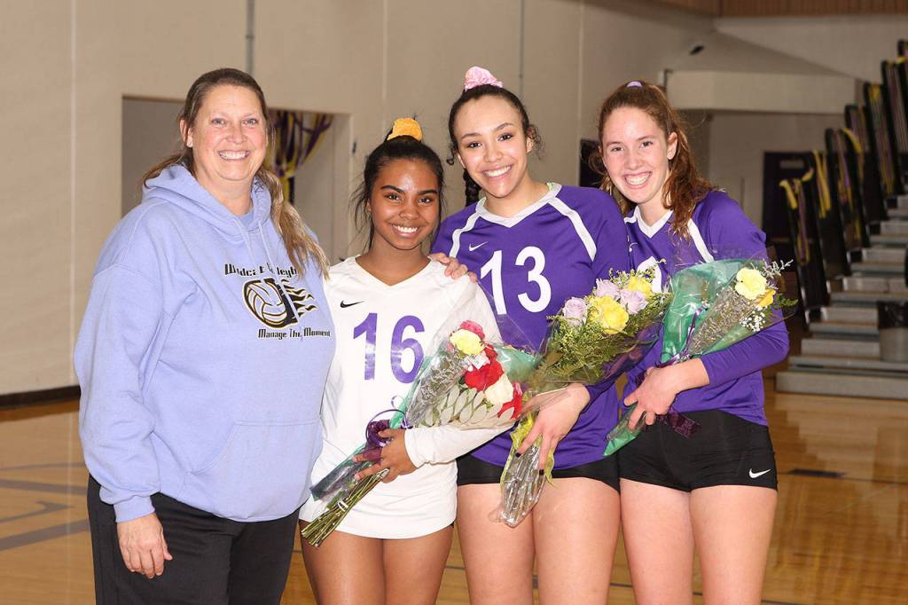 Oak Harbor volleyball coach Kerri Molitor, left, and seniors Jaslin Webster, Jasmine Ford and Leielle Salinger.