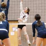 Maddie Vondrak fires by a Sultan block.(Photo by John Fisken)