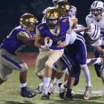 Landon Cantrell (4) tries to shed a Pioneer defender.(Photo by John Fisken)