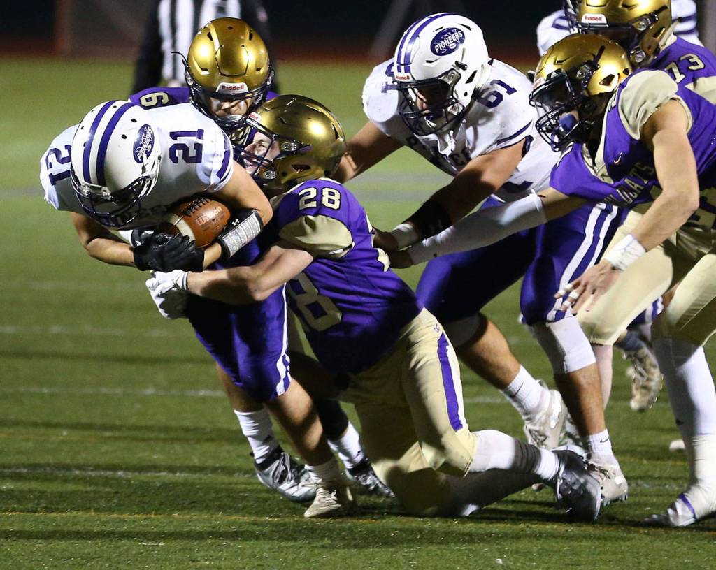Gabriel Daggett (28) and Dominic Dean bring down Nooksack Valleys Scout Whittern.(Photo by John Fisken)