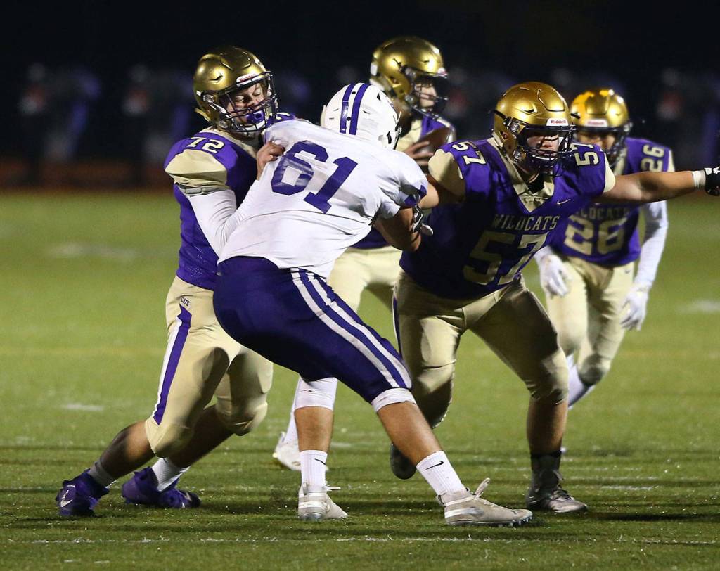 Oak Harbors Jackson Higman (72) and Justin Campbell block the Pioneers Easton Zylstra.(Photo by John Fisken)