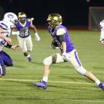 Matt Kelley tries to pick up some more yards for Oak Harbor.(Photo by John Fisken)